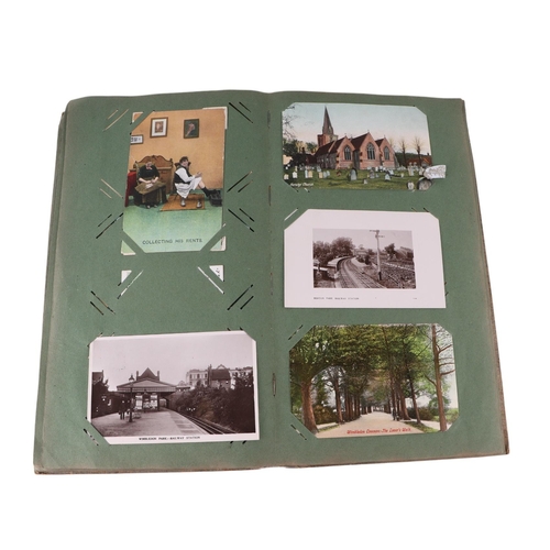 722 - An Edwardian postcard album containing topographical and comical cards; together with some loose pos... 