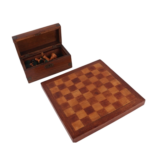 73 - A Staunton pattern boxwood and ebonised chess set with associated chess board, king height 7.5cms.