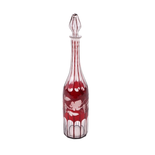 739 - A Bohemian ruby flashed glass decanter and stopper with grape and vine engraved decoration, 39cms hi... 