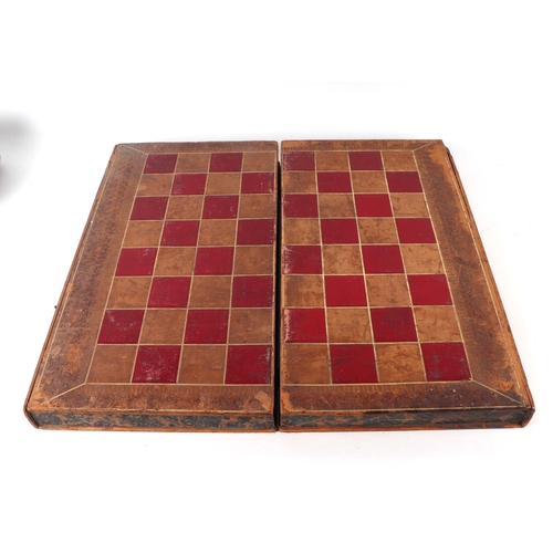 74 - An antique boxwood and ebony chess set, king height 8.5cms, contained in a Victorian leather book fo... 