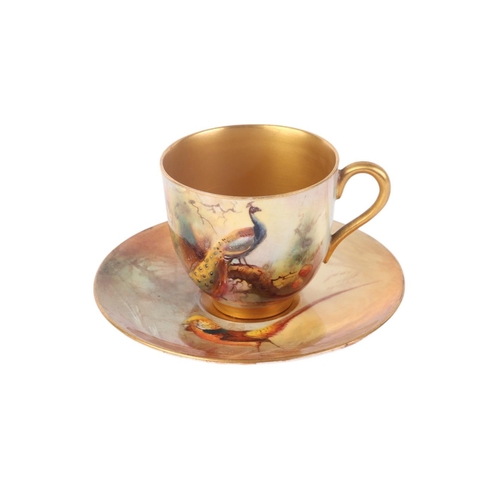 746 - A Royal Worcester cabinet cup and saucer, the cup decorated with a peacock, the saucer decorated wit... 