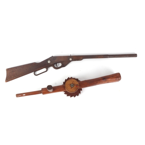 75 - A mid 20th century toy Winchester rifle pop gun; together with a scratch built machine gun with revo... 