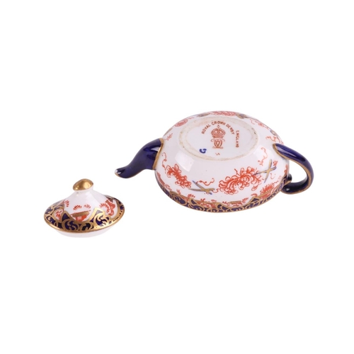 751 - A group of miniature ceramics to include a Royal Crown Derby teapot; a Royal Crown Derby cup and sau... 