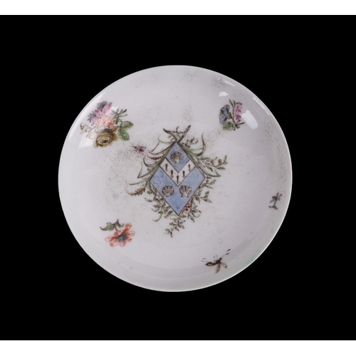 752 - An English 18th century tea bowl and saucer decorated with insects and flowers with central armorial... 