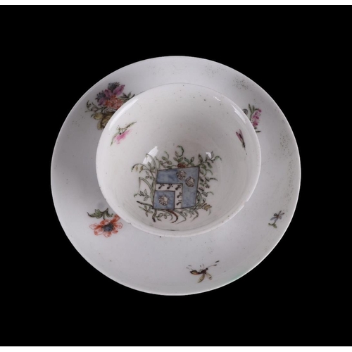 752 - An English 18th century tea bowl and saucer decorated with insects and flowers with central armorial... 