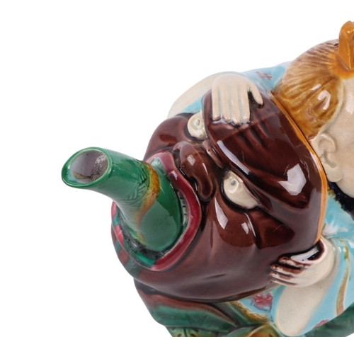 764 - A late Victorian (circa 1870) Minton majolica Chinaman teapot and cover, 19cms wide.