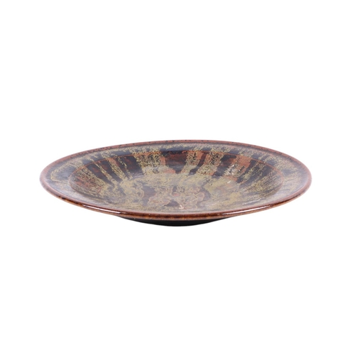 766 - A glazed Studio pottery plate with impressed mark to the underside, 33cms diameter.