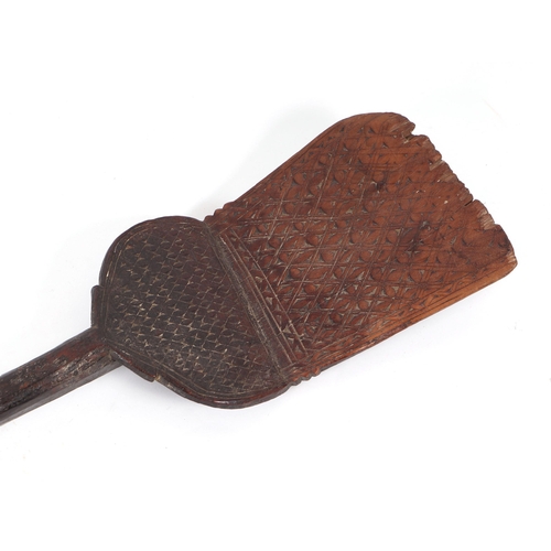 802 - A large ethnic paddle or rice shovel with chip carved decoration, 163cms long.