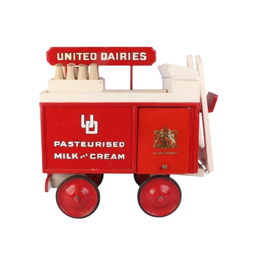 81 - A scratch built painted wooden United Dairies milk cart, 41cms long.