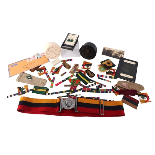 817 - A large collection of military items to include cap badges, shell cases and other items.