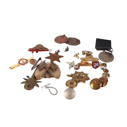 817 - A large collection of military items to include cap badges, shell cases and other items.