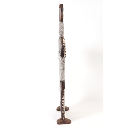 84 - A pair of African tribal Namji figures with cowrie shell decoration, each 103cms high (2).