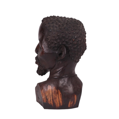 86 - Israel Chikumbirike (Zimbabwe school b1954) - a large carved ebony bust of an African man wearing a ... 