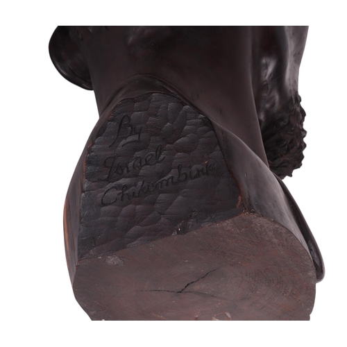 86 - Israel Chikumbirike (Zimbabwe school b1954) - a large carved ebony bust of an African man wearing a ... 