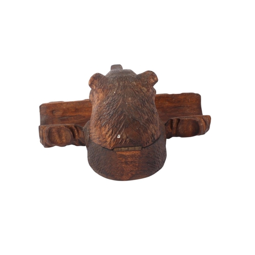 942 - A Black Forest bear desk stand with inkwell and pen tray, 14cms wide.