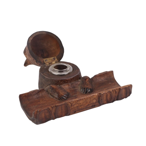 942 - A Black Forest bear desk stand with inkwell and pen tray, 14cms wide.