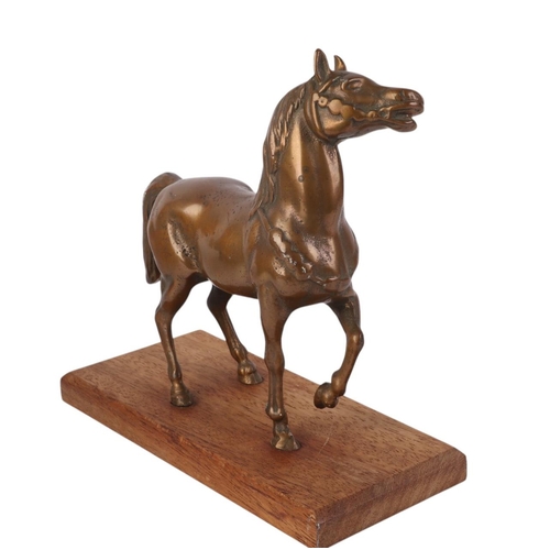 944 - A cast bronze model of a horse on a wooden plinth, 16cms long.