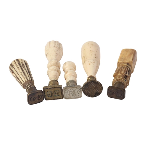 953 - A quantity of 19th century and later bone handled desk seals, the largest 9cms high.