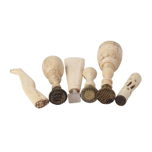 953 - A quantity of 19th century and later bone handled desk seals, the largest 9cms high.