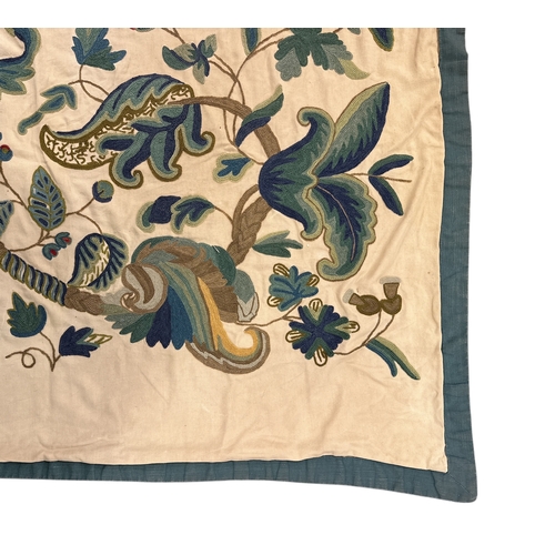 705 - A large crewel work style wall hanging depicting birds, animals, mythical beasts and fruiting foliag... 