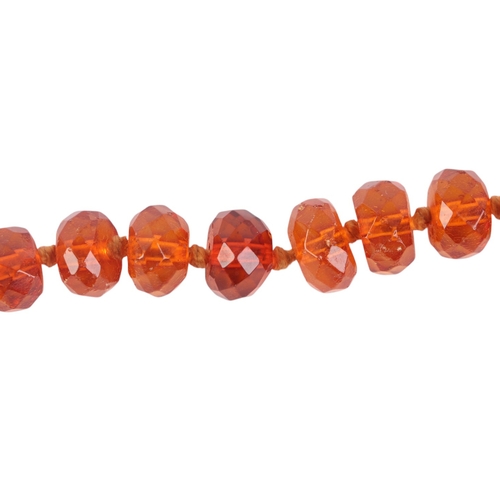 544 - A faceted amber bead necklace, approx 22g; together with an amber pebble bead necklace, 29g (2).