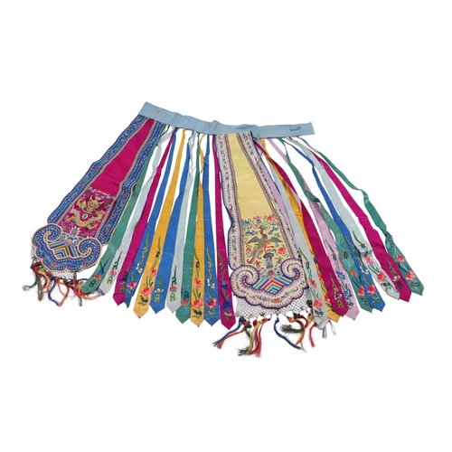 600 - An antique Chinese phoenix tail skirt with fine silk embroidered panels.