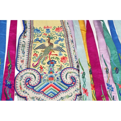 600 - An antique Chinese phoenix tail skirt with fine silk embroidered panels.