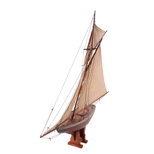 796 - A large scratch built pond yacht on stand, 150cms long, 180cms high including stand.