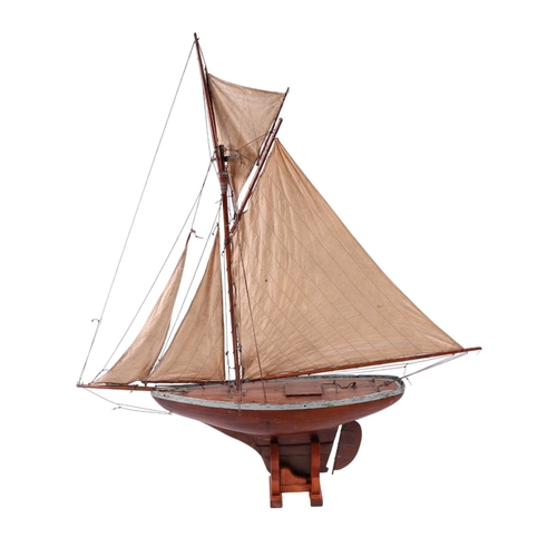 796 - A large scratch built pond yacht on stand, 150cms long, 180cms high including stand.