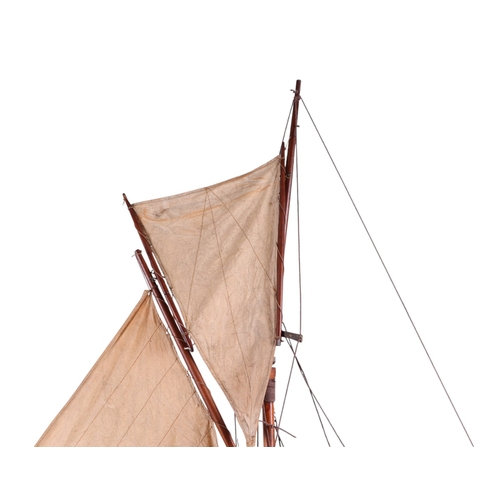 796 - A large scratch built pond yacht on stand, 150cms long, 180cms high including stand.