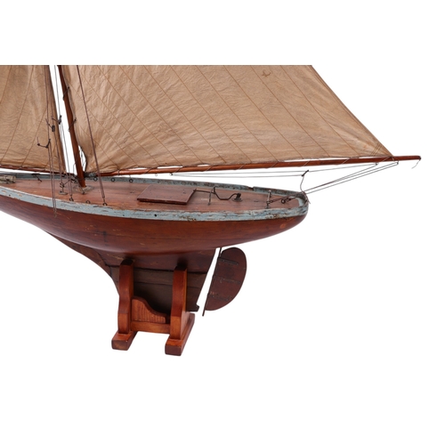 796 - A large scratch built pond yacht on stand, 150cms long, 180cms high including stand.