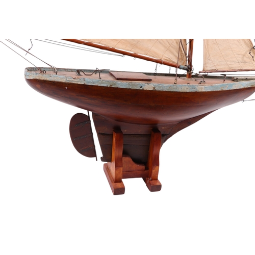 796 - A large scratch built pond yacht on stand, 150cms long, 180cms high including stand.