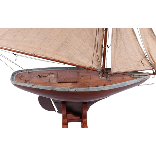 796 - A large scratch built pond yacht on stand, 150cms long, 180cms high including stand.