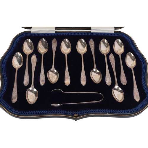 444 - A cased set of twelve silver teaspoons and matching sugar tongs with ornate engraved handles, Sheffi... 