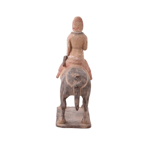 631 - A Chinese Tang Dynasty style polychrome painted terracotta model of a horse and rider, 32cms high to... 