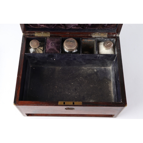 261 - A Victorian brass bound rosewood toilet box with fitted interior containing silver mounted jars and ... 