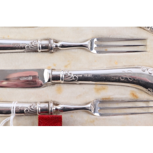 453 - A cased twelve-piece setting silver handled dessert cutlery with pistol grips, initialled 'H'.