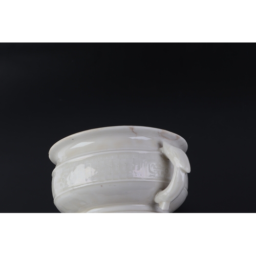 623 - A Chinese blanc de chine two-handled censer with archaic decoration, 11.5cms diameter.