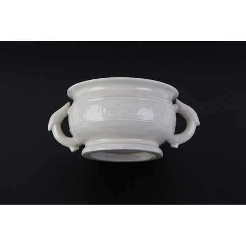 623 - A Chinese blanc de chine two-handled censer with archaic decoration, 11.5cms diameter.