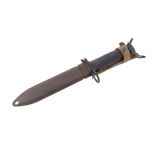 120 - A military bayonet with canvas frog and green metal scabbard, 33cms long.