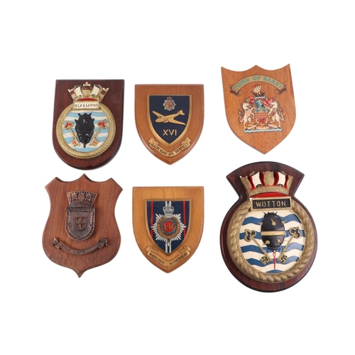 124 - A collection of Naval  insignia plaques mounted on wooden shields, including Portsmouth, Glaserton, ... 