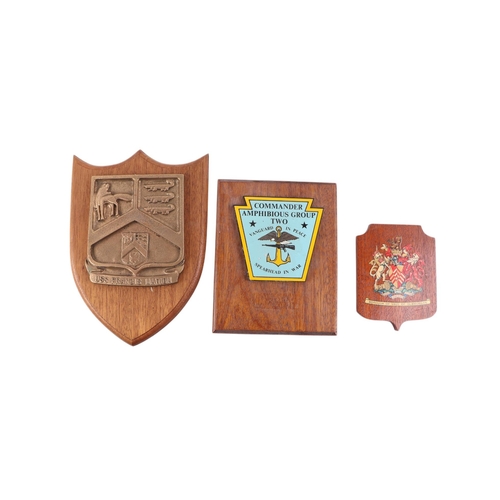 124 - A collection of Naval  insignia plaques mounted on wooden shields, including Portsmouth, Glaserton, ... 