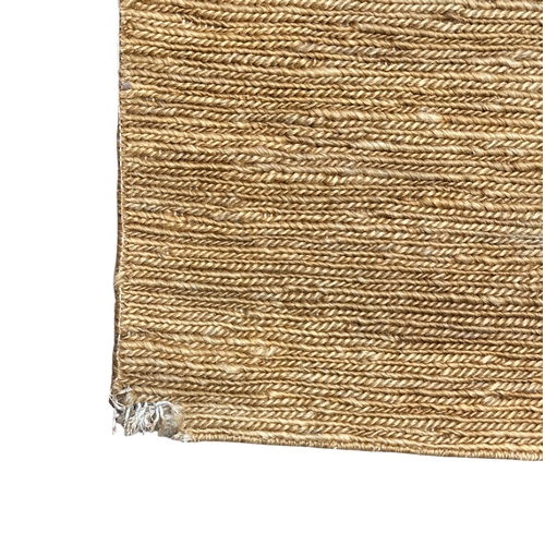 129 - A large hessian floor rug. 242 by 433cms.