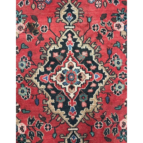 136 - A Persian Hamadan carpet,  the central diamond medallion within floral borders, on a beige ground, 1... 