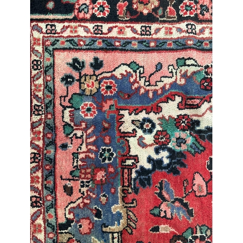 136 - A Persian Hamadan carpet,  the central diamond medallion within floral borders, on a beige ground, 1... 