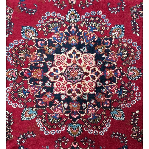 156 - A Persian Meshed woollen hand knotted rug with central floral medallion within floral borders, on a ... 