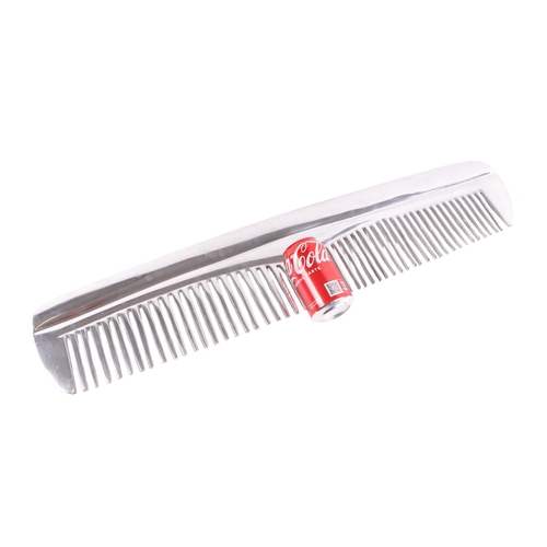 456 - A large shop display novelty polished aluminium comb, 78cms long.