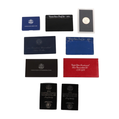 458 - US silver proof and uncirculated coin sets including two 1984 silver dollars and 1989 2-coin proof s... 