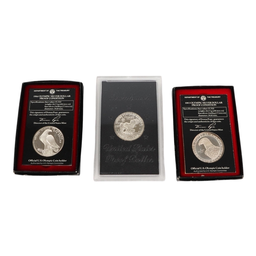 458 - US silver proof and uncirculated coin sets including two 1984 silver dollars and 1989 2-coin proof s... 