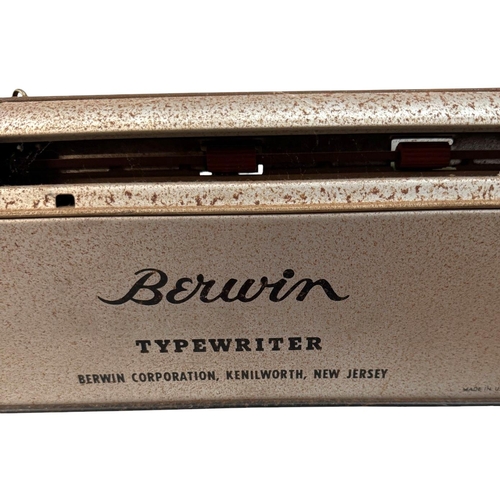 69 - A Berwin tin plate toy typewriter, thee spinning tops, a cast money box and a tin plate fairground t... 